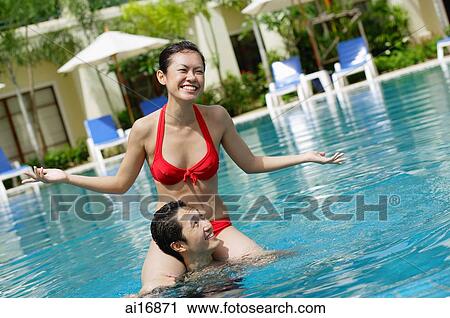 Woman sitting on mans shoulders in swimming pool View Large Photo Image Stock Image - Woman sitting on mans shoulders in swimming pool . Fotosearch