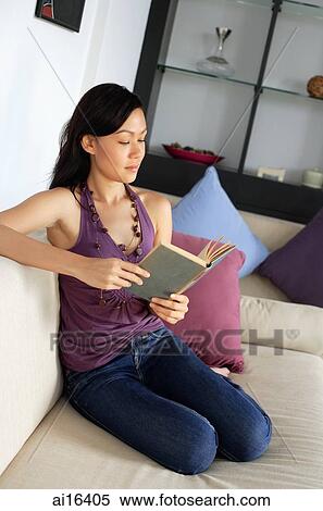 Woman sitting on sofa, reading a book View Large Photo Image Stock Photography - Woman sitting on sofa, reading a book . Fotosearch