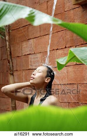 Woman taking outdoor shower, eyes closed View Large Photo Image Stock Image - Woman taking outdoor shower, eyes closed . Fotosearch