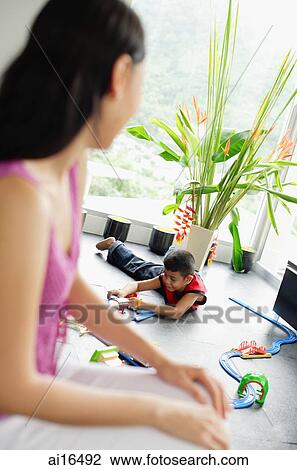 Woman turning to look at child in the background View Large Photo Image Stock Image - Woman turning to look at child in the background . Fotosearch