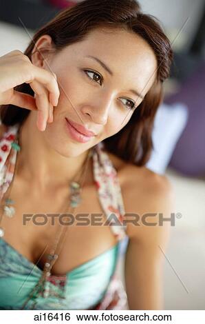 Woman with hand on face, looking away, portrait View Large Photo Image Stock Photograph - Woman with hand on face, looking away, portrait. Fotosearch