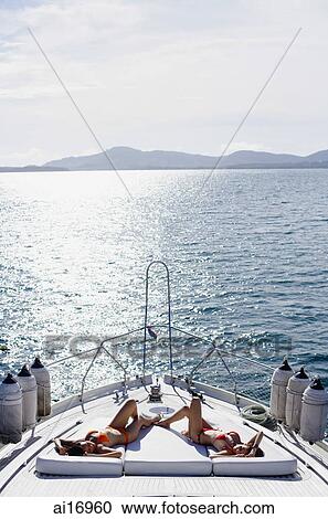 Women on boat deck, sunbathing View Large Photo Image Stock Image - Women on boat deck, sunbathing . Fotosearch