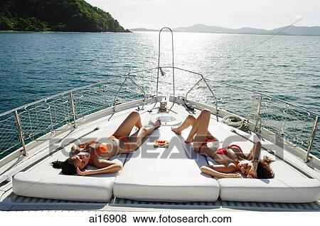Women sunbathing on boat deck View Large Photo Image Stock Photo - Women sunbathing on boat deck . Fotosearch