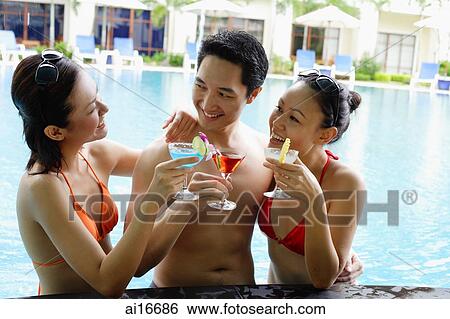 Young adults in swimming pool with cocktail drinks View Large Photo Image Stock Photograph - Young adults in swimming pool with cocktail drinks. Fotosearch