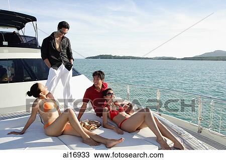 Young adults on boat deck View Large Photo Image Stock Image - Young adults on boat deck. Fotosearch