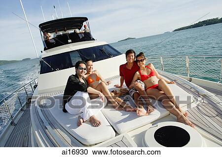 Young adults sitting on boat deck View Large Photo Image Stock Image - Young adults sitting on boat deck . Fotosearch