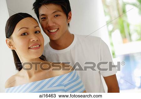 Young couple looking at camera View Large Photo Image Stock Image - Young couple looking at camera . Fotosearch