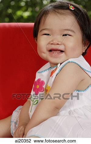 Stock Image - Baby girl smiling, portrait. Fotosearch