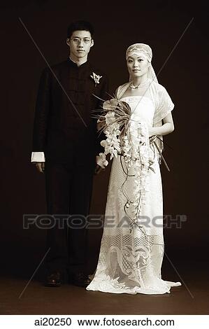 Stock Image - Bride and Groom posing for studio portrait. Fotosearch