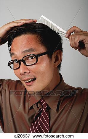 Stock Photo - Businessman combing his hair. Fotosearch