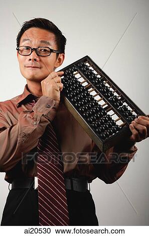 Businessman with Chinese abacus, looking at camera View Large Photo Image Stock Image - Businessman with Chinese abacus, looking at camera. Fotosearch