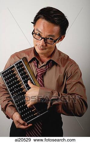 Businessman with Chinese abacus View Large Photo Image Stock Photo - Businessman with Chinese abacus. Fotosearch