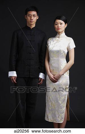 Couple dressed in traditional Chinese attire, posing for studio portrait View Large Photo Image Stock Photograph - Couple dressed in traditional Chinese attire, posing for studio portrait. Fotosearch