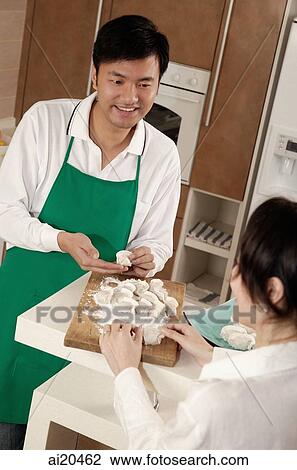 Couple in kitchen kneading dough View Large Photo Image Stock Image - Couple in kitchen kneading dough. Fotosearch