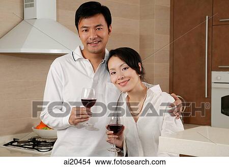 Couple in kitchen, looking at camera, portrait View Large Photo Image Picture - Couple in kitchen, looking at camera, portrait. Fotosearch