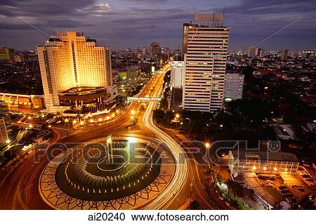 Early evening view of the Hotel Indonesia roundabout, Welcome monument and buildings along Jalan Thamrin, Jakarta View Large Photo Image Stock Image - Early evening view of the Hotel Indonesia roundabout, Welcome monument and buildings along Jalan Thamrin, Jakarta. Fotosearch
