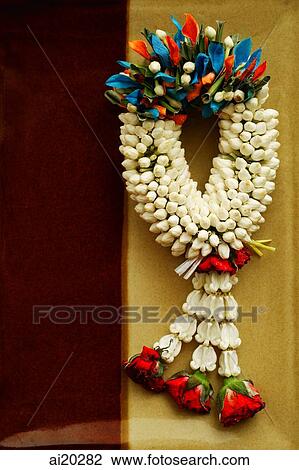 Stock Image - Fragrant flower wreath on decorative clay plate. Fotosearch