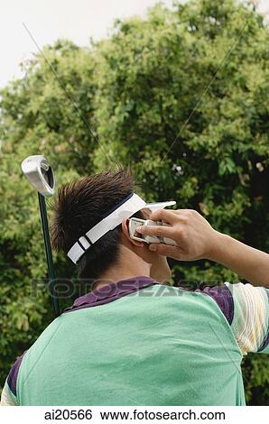 Male golfer using mobile phone, rear view View Large Photo Image Stock Photograph - Male golfer using mobile phone, rear view. Fotosearch