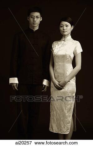 Man and woman dressed in traditional Chinese attire, posing for studio portrait View Large Photo Image Stock Photo - Man and woman dressed in traditional Chinese attire, posing for studio portrait. Fotosearch