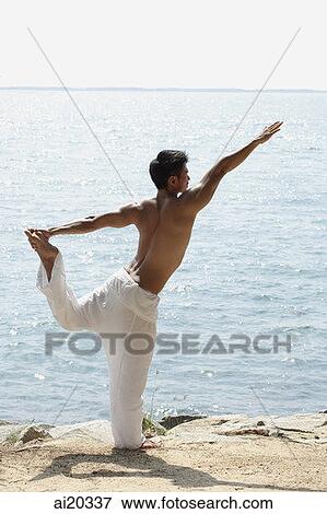 Man doing yoga on the beach View Large Photo Image Stock Photo - Man doing yoga on the beach. Fotosearch