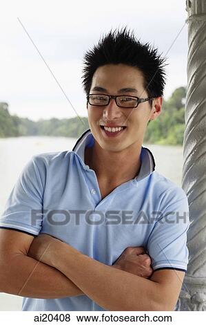 Stock Photo - Man in blue polo shirt, smiling, looking at camera. Fotosearch