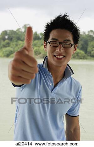 Man in polo shirt and glasses, making a thumbs up sign View Large Photo Image Picture - Man in polo shirt and glasses, making a thumbs up sign. Fotosearch