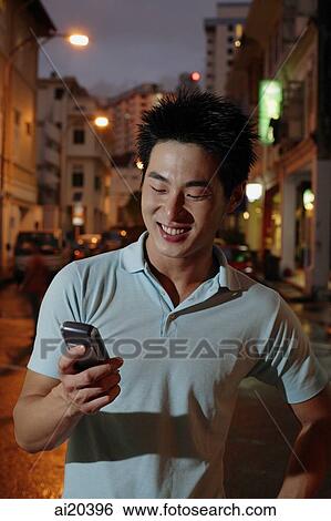 Man looking at PDA View Large Photo Image Stock Photograph - Man looking at PDA. Fotosearch