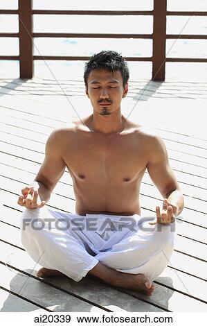 Man sitting on boardwalk, meditating View Large Photo Image Stock Photo - Man sitting on boardwalk, meditating. Fotosearch