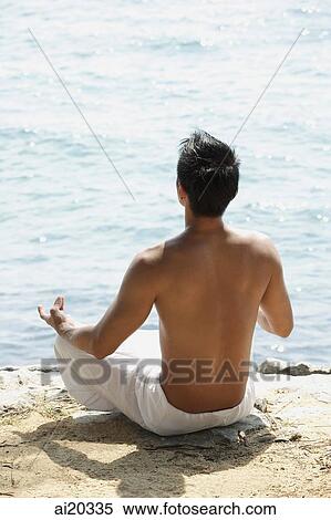 Man sitting on the beach, meditating View Large Photo Image Stock Photography - Man sitting on the beach, meditating. Fotosearch
