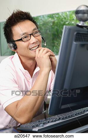 Man using computer and webcam View Large Photo Image Stock Photo - Man using computer and webcam. Fotosearch