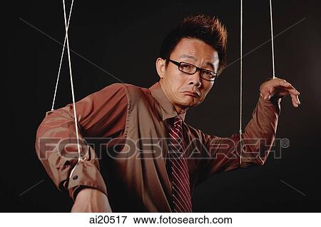 Man with marionette strings attached to his hands, looking at camera, frowning View Large Photo Image Stock Photo - Man with marionette strings attached to his hands, looking at camera, frowning. Fotosearch