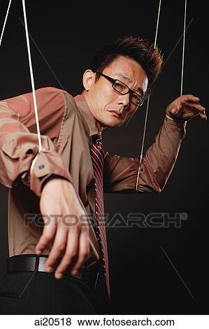 Man with marionette strings attached to his hands, looking at camera, frowning View Large Photo Image Stock Photo - Man with marionette strings attached to his hands, looking at camera, frowning. Fotosearch