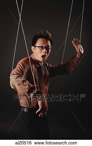 Man with marionette strings attached to his hands, looking at camera, mouth open View Large Photo Image Stock Photograph - Man with marionette strings attached to his hands, looking at camera, mouth open. Fotosearch