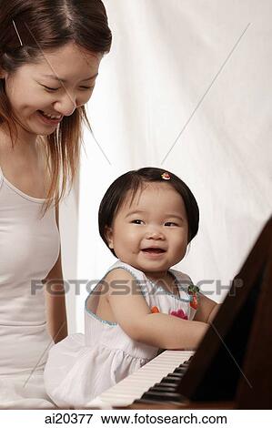 Mother and young daughter playing the piano View Large Photo Image Stock Photo - Mother and young daughter playing the piano. Fotosearch