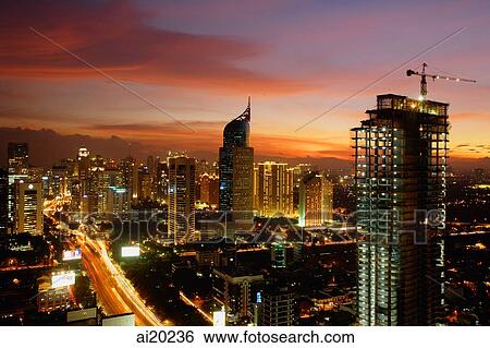 Stock Photograph - Sunset view of the CBD, with building construction and skyscrapers along Jalan Jend Sudirman. Fotosearch