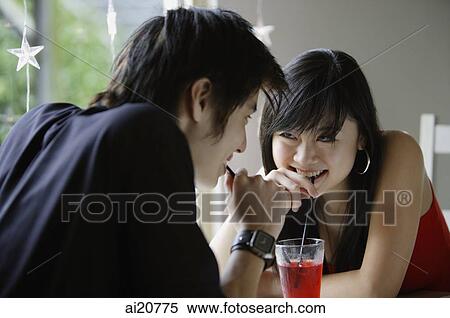 Teenage couple sharing a drink View Large Photo Image Stock Photography - Teenage couple sharing a drink. Fotosearch