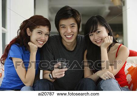 Teenagers sitting side by side, smiling at camera, portrait View Large Photo Image Stock Photo - Teenagers sitting side by side, smiling at camera, portrait. Fotosearch