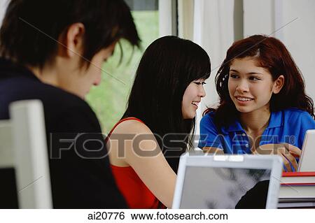Stock Photograph - Teenagers using laptop. Fotosearch