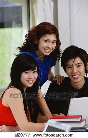 Teenagers with laptop and books, smiling at camera, portrait View Large Photo Image Stock Photo - Teenagers with laptop and books, smiling at camera, portrait. Fotosearch
