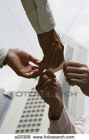 Two businessmen exchanging business card, low angle view View Large Photo Image Stock Photo - Two businessmen exchanging business card, low angle view. Fotosearch