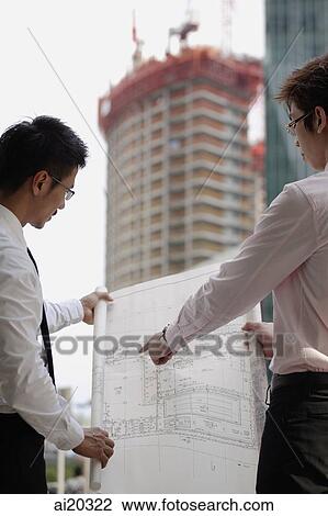 Two men looking at blueprint View Large Photo Image Stock Image - Two men looking at blueprint. Fotosearch