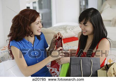 Stock Photography - Two teenage girls with shopping bags. Fotosearch
