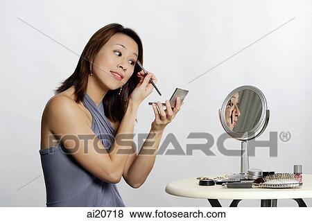 Woman applying make-up View Large Photo Image Stock Photo - Woman applying make-up. Fotosearch