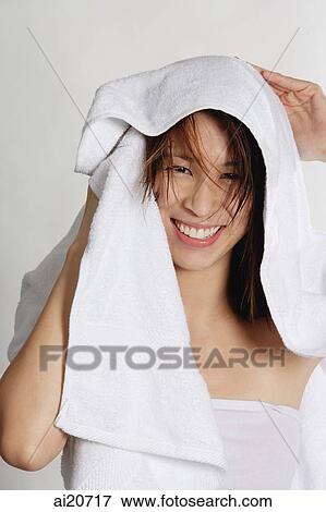 Woman drying her hair with towel, smiling at camera View Large Photo Image Stock Photo - Woman drying her hair with towel, smiling at camera. Fotosearch