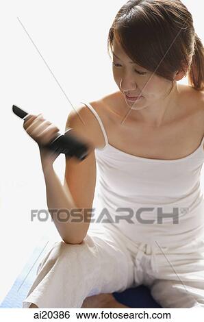 Woman holding dumbbell View Large Photo Image Stock Photograph - Woman holding dumbbell. Fotosearch
