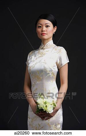 Stock Image - Woman in cheongsam, portrait. Fotosearch