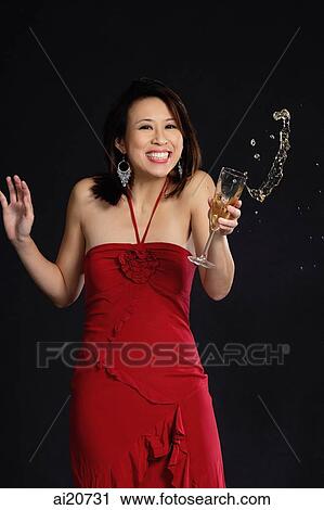 Woman in red dress, holding wine glass, liquid spilling out of glass View Large Photo Image Stock Image - Woman in red dress, holding wine glass, liquid spilling out of glass. Fotosearch