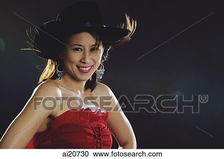 Woman in tube top wearing cowboy hat, smiling at camera View Large Photo Image Stock Image - Woman in tube top wearing cowboy hat, smiling at camera. Fotosearch