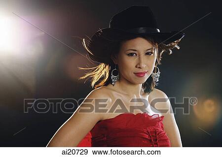 Woman in tube top wearing cowboy hat, looking at camera View Large Photo Image Stock Photo - Woman in tube top wearing cowboy hat, looking at camera. Fotosearch