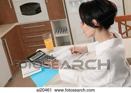 Woman sitting at kitchen counter doing finances View Large Photo Image Stock Image - Woman sitting at kitchen counter doing finances. Fotosearch